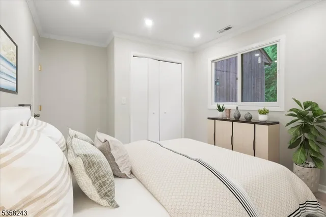 a bedroom with a bed and with potted plant