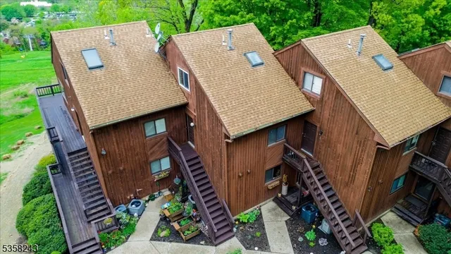 an aerial view of a house with garden space and street view