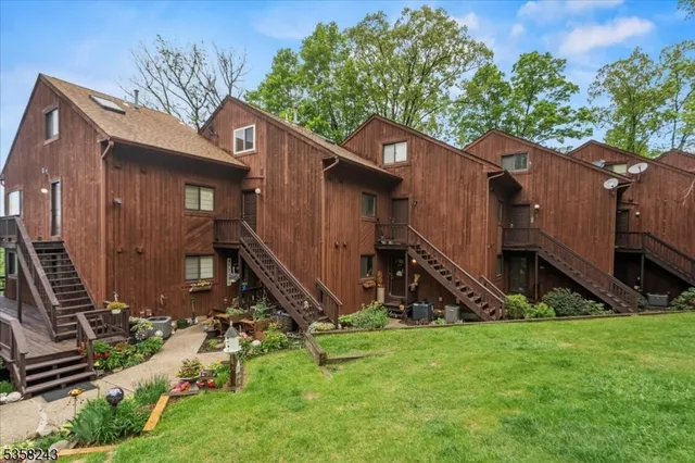 a view of a house with a yard and a wooden fence