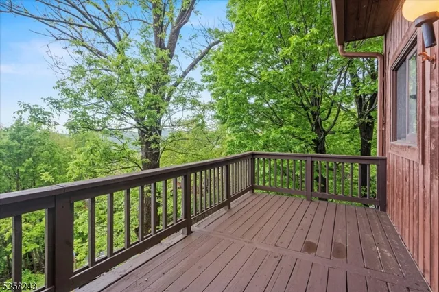 a view of balcony with wooden floor and fence