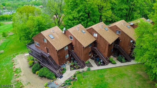 an aerial view of a house with a big yard and large tree