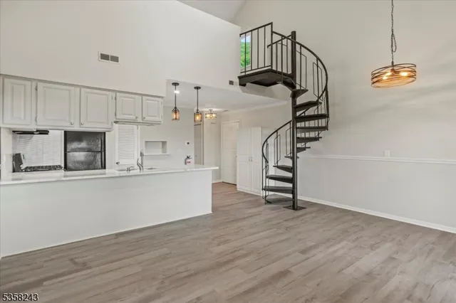 a view of hallway with wooden floor and stairs