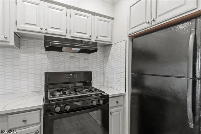 a stove top oven sitting inside of a kitchen
