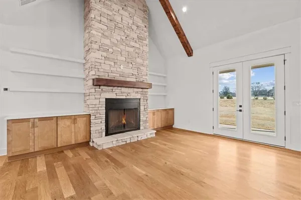 a large white kitchen with a large counter top and stainless steel appliances