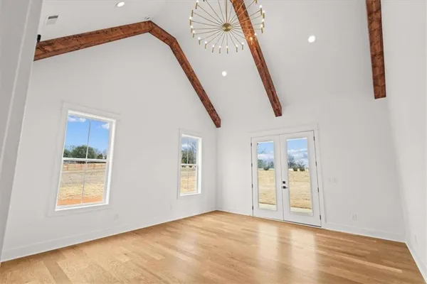 a view of a big room with wooden floor closet and windows