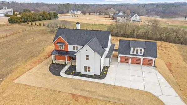 a view of a brick house with wooden fence