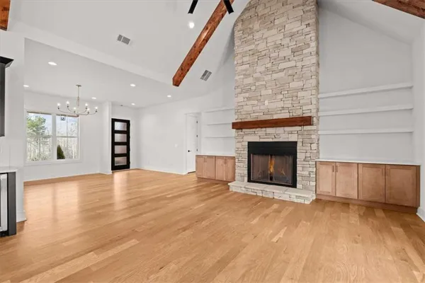 an empty room with window and closet area