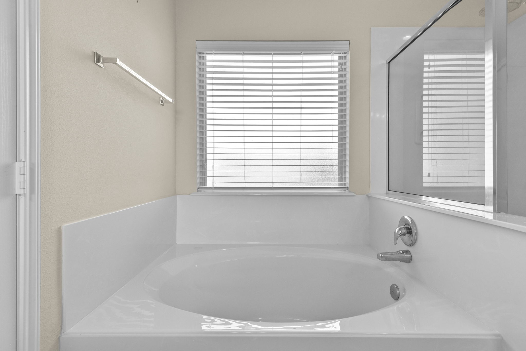 39 Butternut Grove Place Tomball, TX 77375 - Photo 17 of 35 a white bath tub sitting in a bathroom next to a window