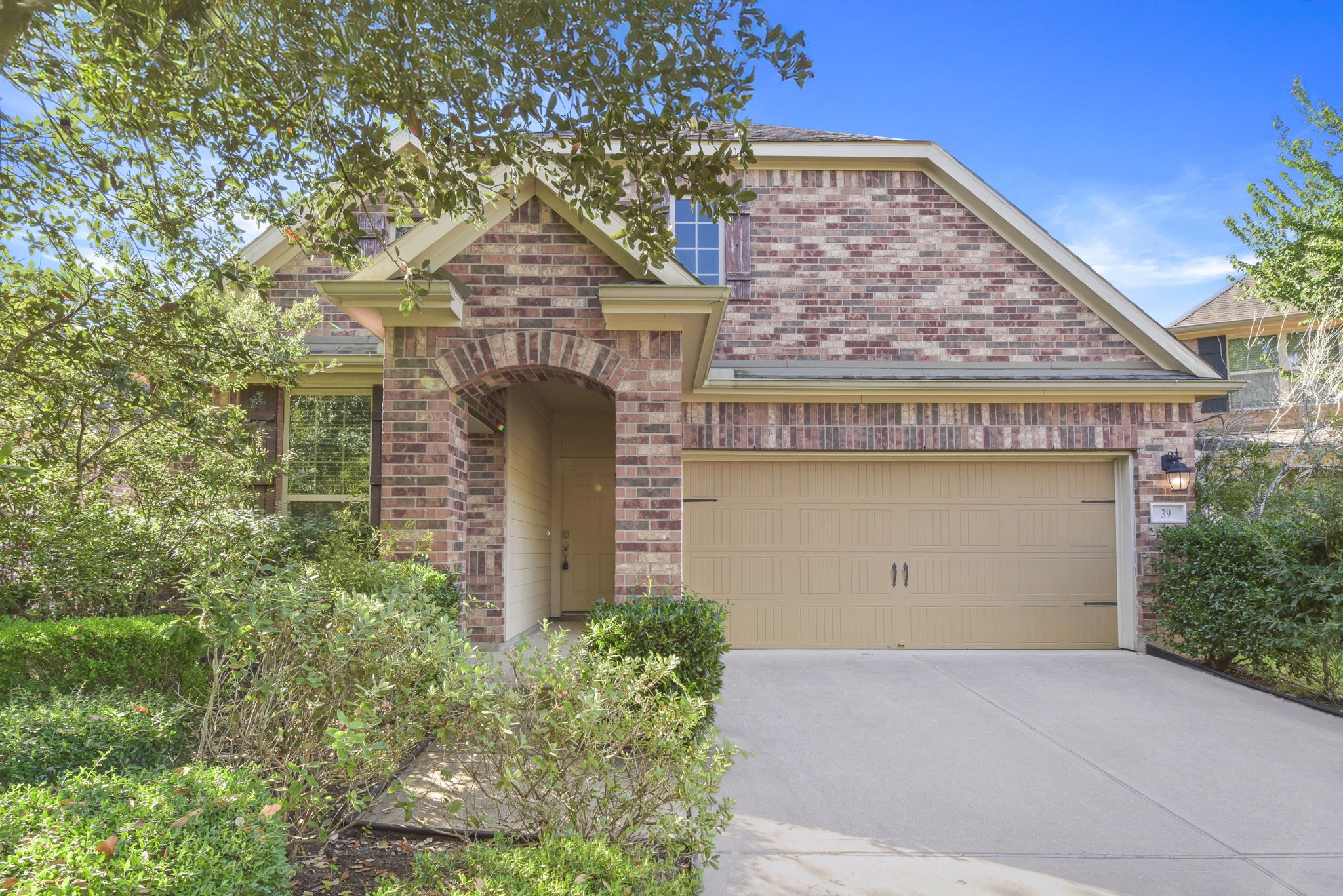39 Butternut Grove Place Tomball, TX 77375 - Photo 2 of 35 front view of house with a dry yard and potted plants
