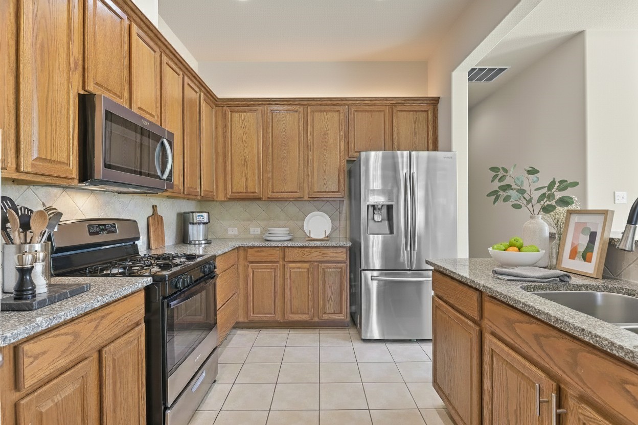 39 Butternut Grove Place Tomball, TX 77375 - Photo 9 of 35 a kitchen with granite countertop stainless steel appliances a refrigerator sink and microwave