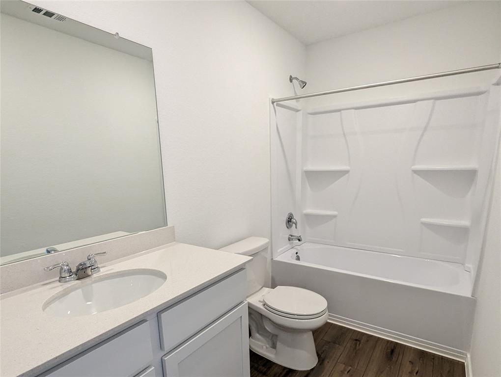 152 Avre Loop Kyle, TX 78640 - Photo 11 of 24 A well-appointed bathroom features a classic shower-tub combination and a clean, functional vanity.