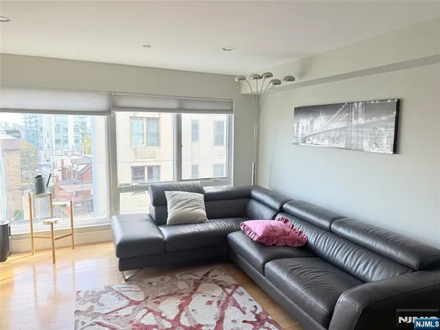 a living room with furniture and a floor to ceiling window