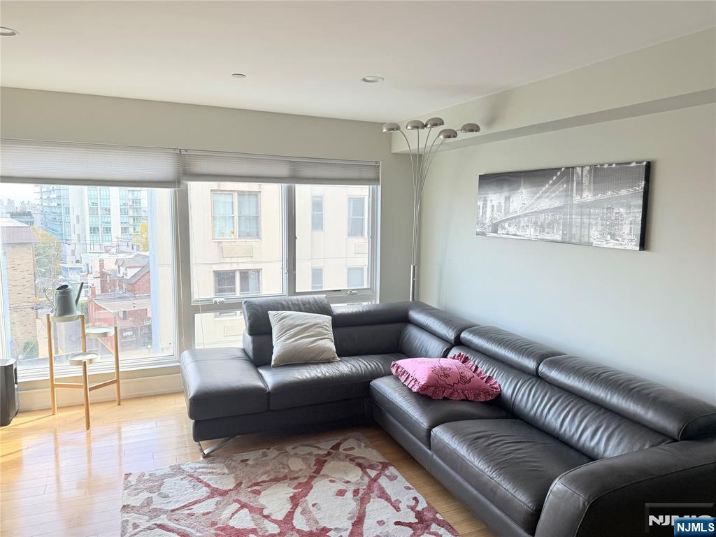 310 Cliff Lane, Unit 4E Cliffside Park, NJ 07010 - Photo 11 of 37 a living room with furniture and a floor to ceiling window