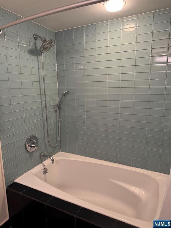 310 Cliff Lane, Unit 4E Cliffside Park, NJ 07010 - Photo 23 of 37 a bathroom with a sink a shower and a bathtub