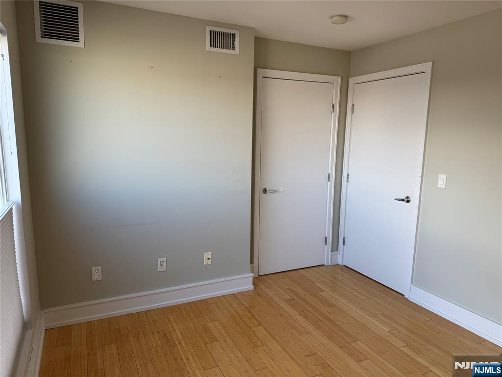 310 Cliff Lane, Unit 4E Cliffside Park, NJ 07010 - Photo 29 of 37 a view of an empty room with wooden floor and a window