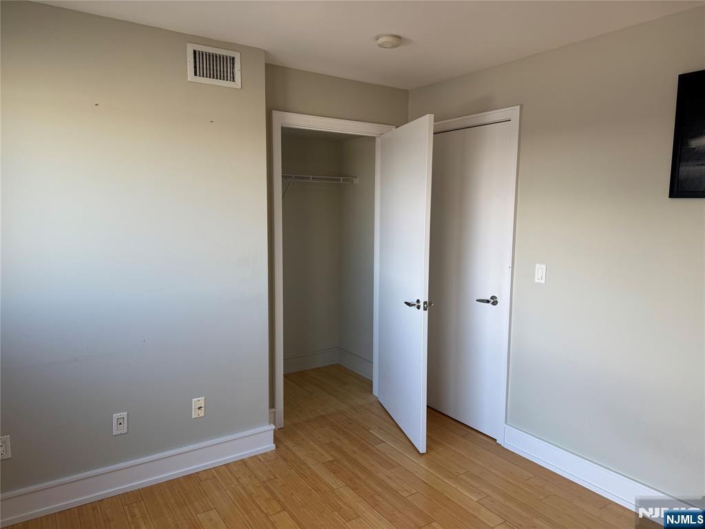 310 Cliff Lane, Unit 4E Cliffside Park, NJ 07010 - Photo 30 of 37 a view of an empty room with wooden floor and closet