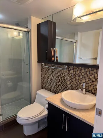 a bathroom with a sink toilet and shower