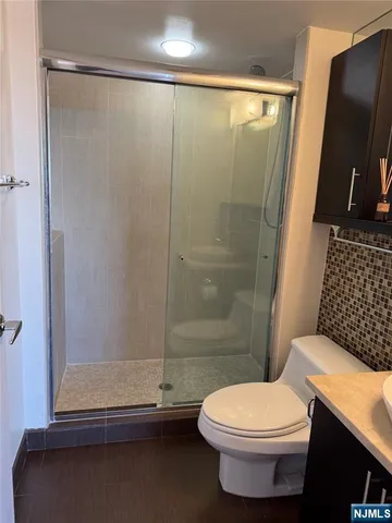 a bathroom with a toilet and a shower