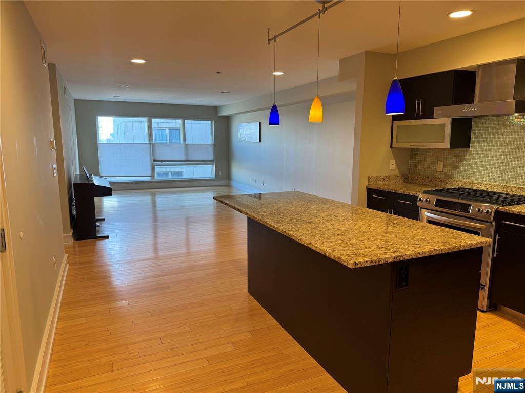 310 Cliff Lane, Unit 4E Cliffside Park, NJ 07010 - Photo 4 of 37 a kitchen with stainless steel appliances granite countertop a sink counter space and cabinets