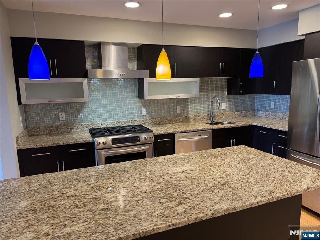 310 Cliff Lane, Unit 4E Cliffside Park, NJ 07010 - Photo 5 of 37 a kitchen with stainless steel appliances granite countertop a sink stove and refrigerator