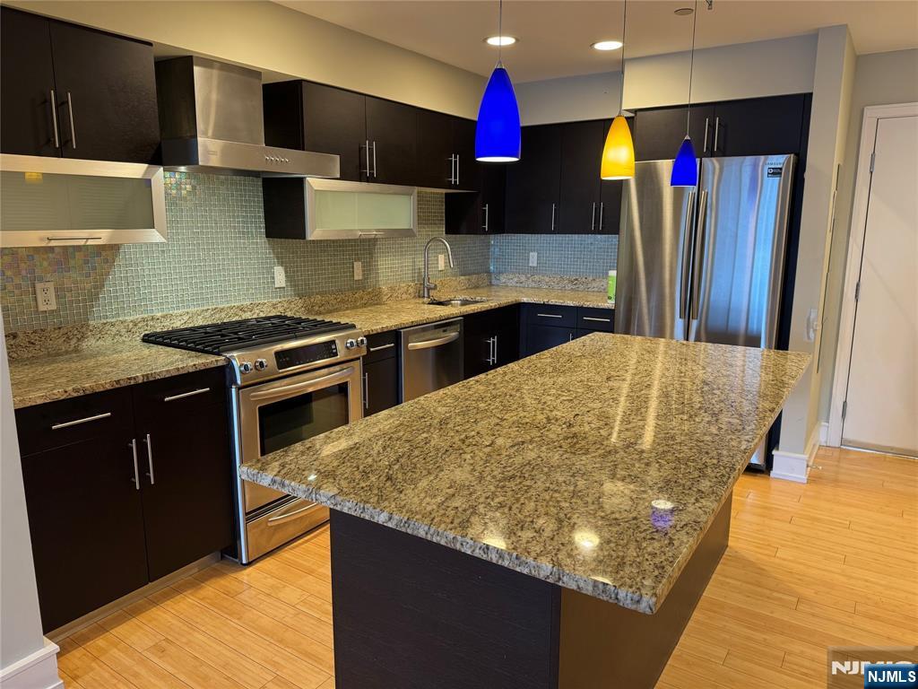 310 Cliff Lane, Unit 4E Cliffside Park, NJ 07010 - Photo 6 of 37 a kitchen with stainless steel appliances granite countertop a stove a refrigerator and a sink