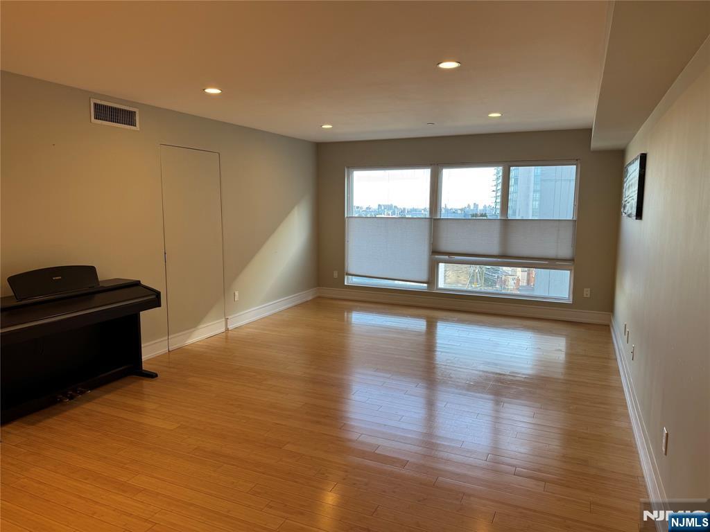 310 Cliff Lane, Unit 4E Cliffside Park, NJ 07010 - Photo 8 of 37 a view of an empty room with wooden floor and a window