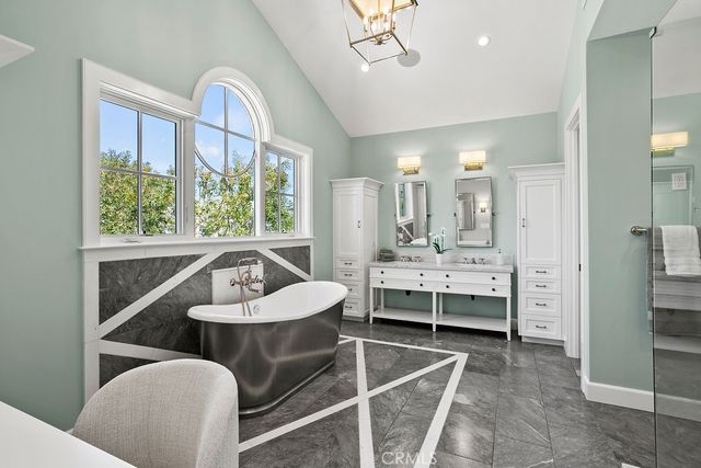 a kitchen view with table chairs and chandelier