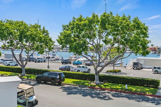 a view of a balcony with wooden floor and iron fence