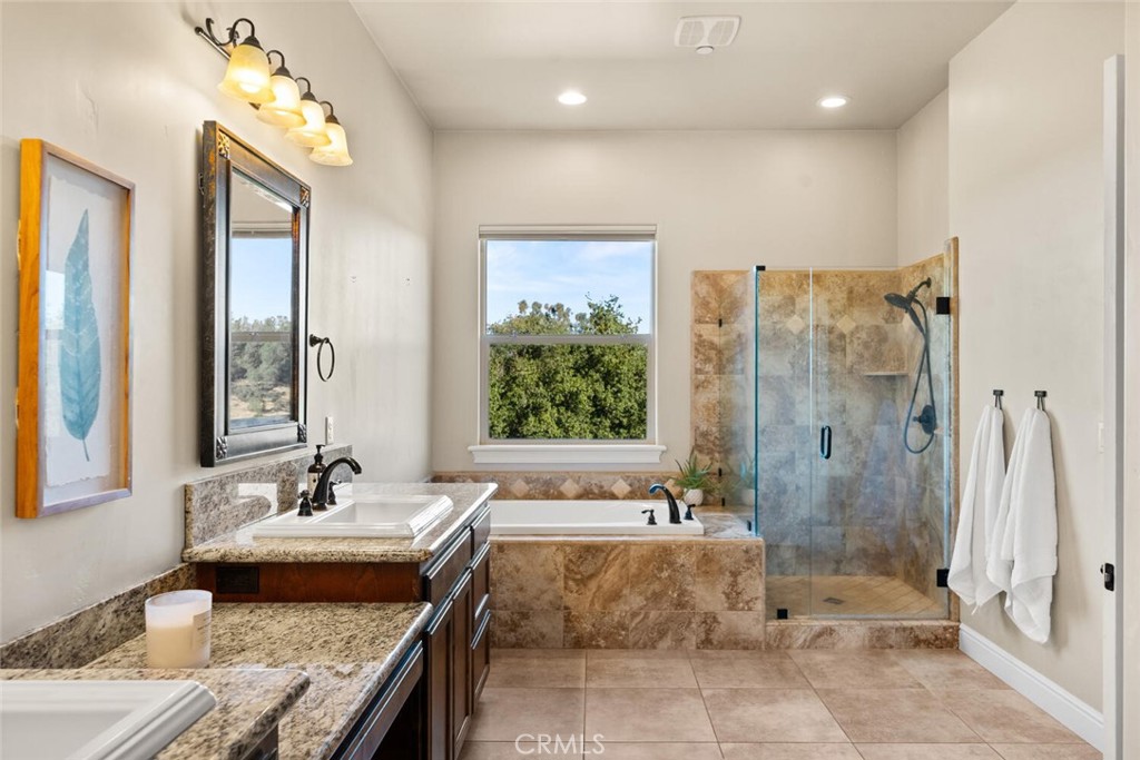 3368 Summit Ridge Terrace Chico, CA 95928 - Photo 20 of 44 a bathroom with a granite countertop bathtub shower sink and mirror