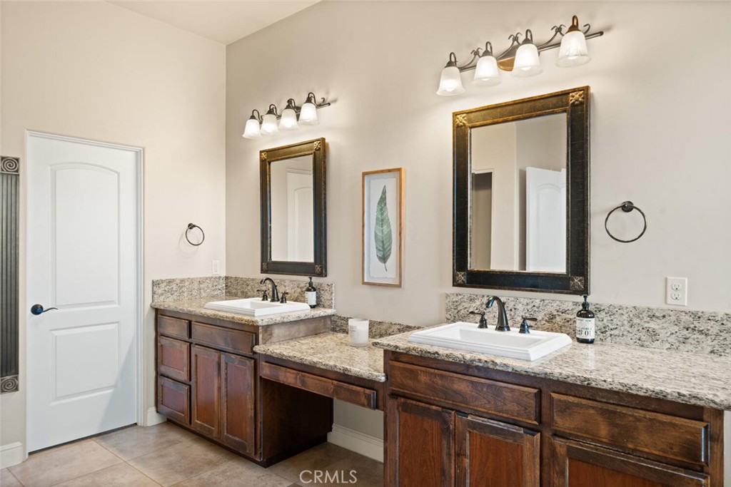 3368 Summit Ridge Terrace Chico, CA 95928 - Photo 21 of 44 a bathroom with a granite countertop sink and a mirror