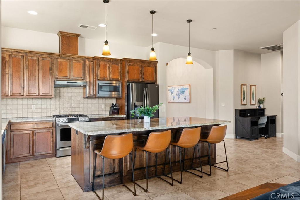 3368 Summit Ridge Terrace Chico, CA 95928 - Photo 7 of 44 a kitchen with a stove a sink and a refrigerator