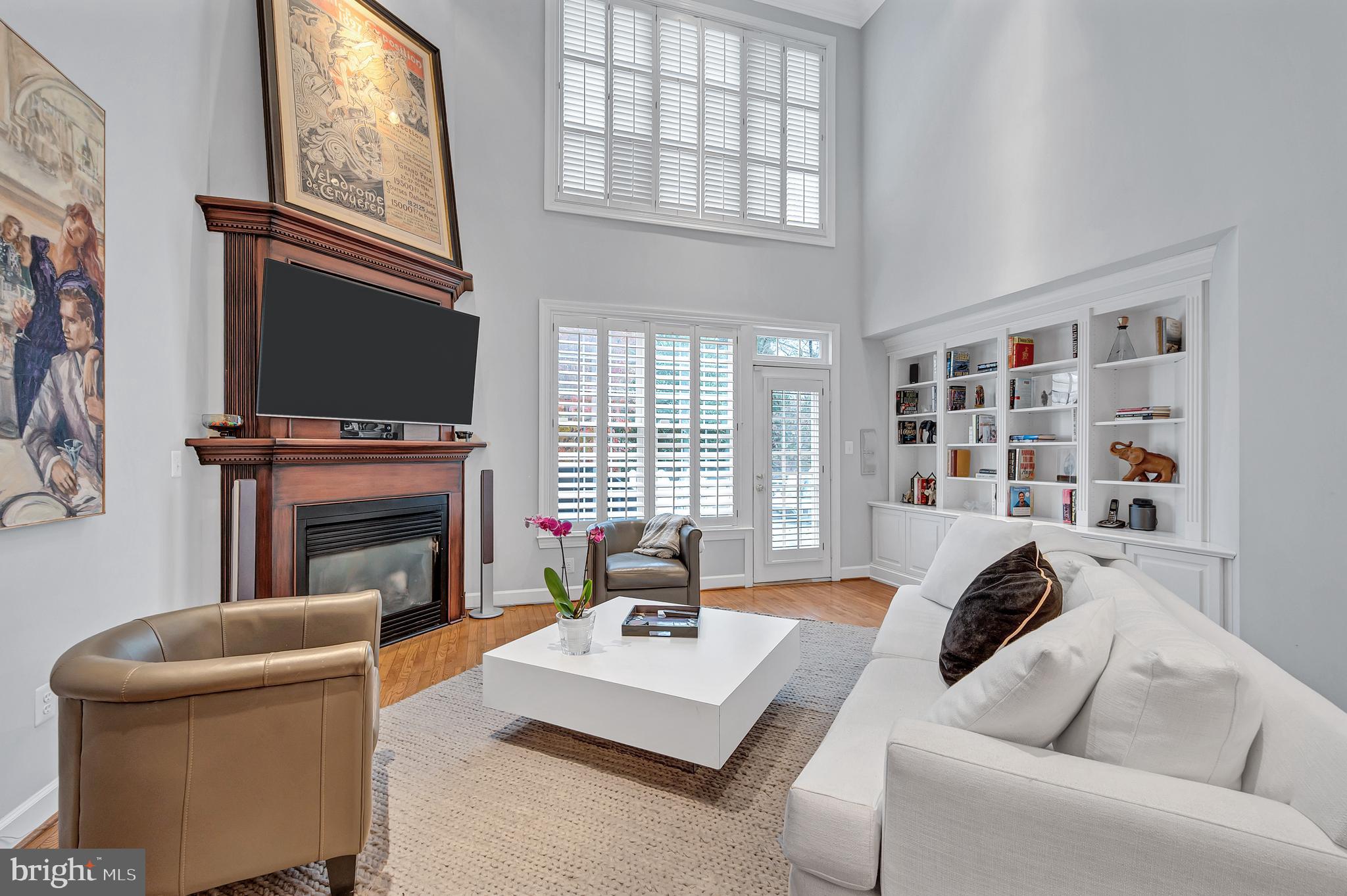 10918 Bells Ridge Drive Potomac, MD 20854 - Photo 15 of 41 a living room with furniture a fireplace and a flat screen tv