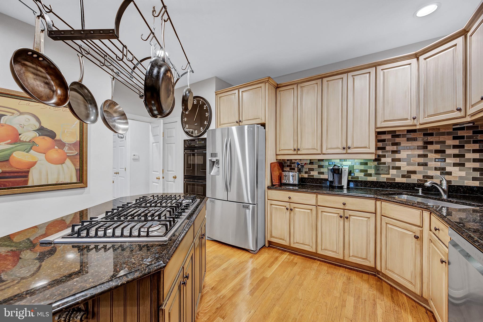 10918 Bells Ridge Drive Potomac, MD 20854 - Photo 21 of 41 a kitchen with stainless steel appliances granite countertop a sink a stove and refrigerator
