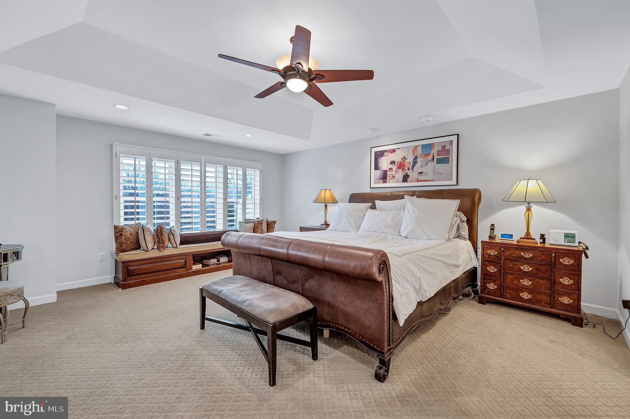 10918 Bells Ridge Drive Potomac, MD 20854 - Photo 23 of 41 a spacious bedroom with a bed and a chandelier