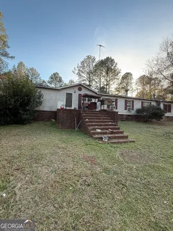 a view of a house with a yard and a garden