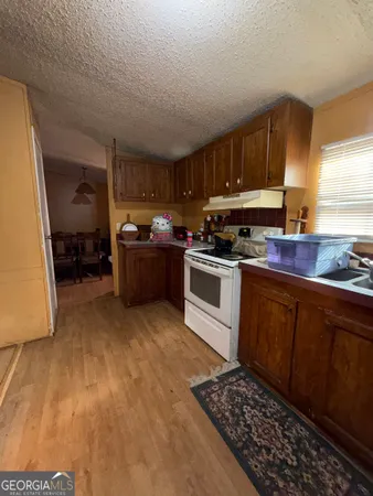 a kitchen with wooden cabinets and a stove top oven