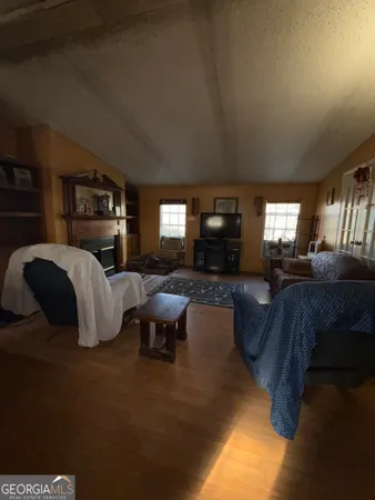 a living room with furniture large window and flat screen tv