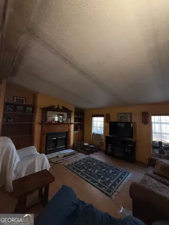 a living room with furniture rug and fireplace