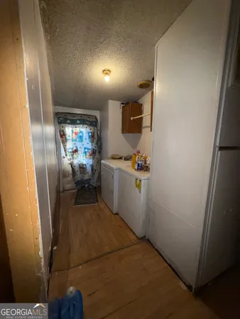 a utility room with cabinets washer and dryer