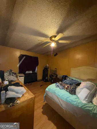 a bedroom with bed and a chandelier