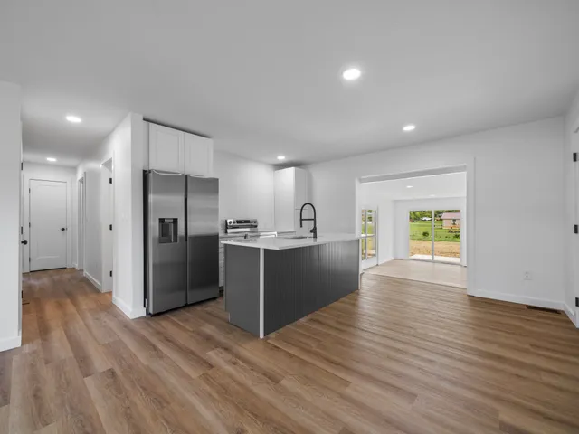 a view of kitchen with refrigerator microwave and wooden floor