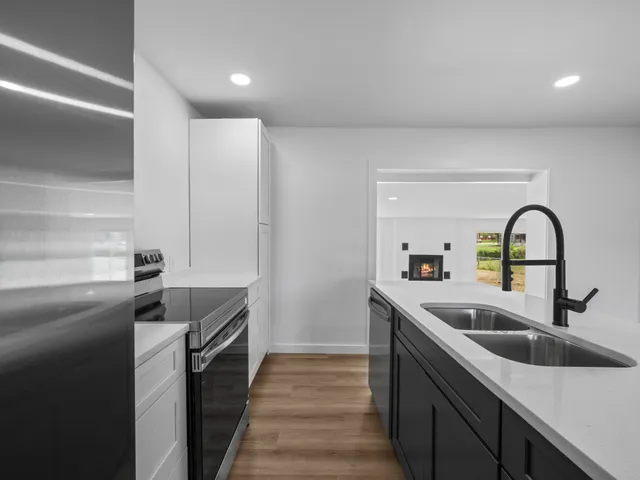 a kitchen with stainless steel appliances a sink and cabinets