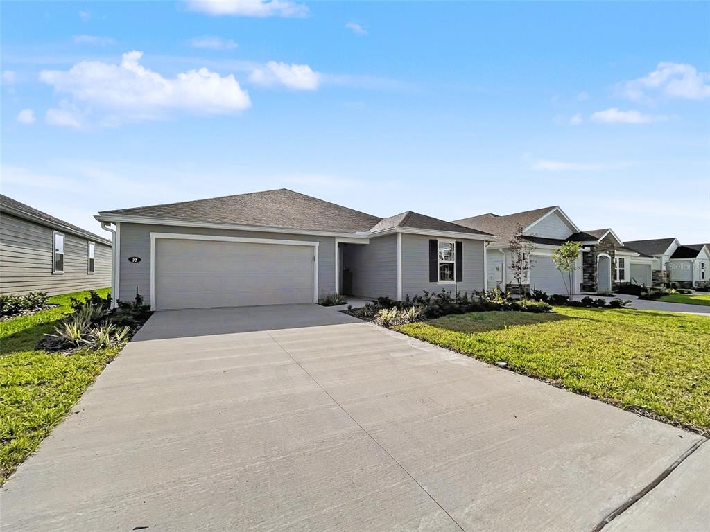 55 Signet Circle Flagler Beach, FL 32136 - Photo 2 of 39 a front view of a house with a yard and garage