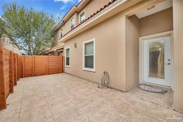 a view of a house with a wooden fence