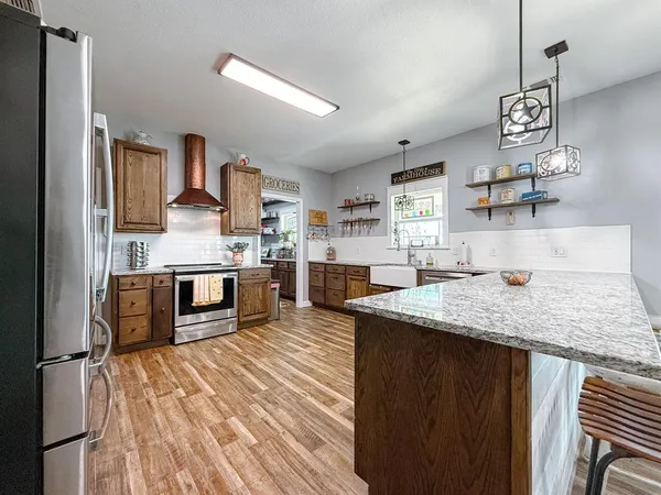 a kitchen with stainless steel appliances granite countertop a sink counter space cabinets and a counter space