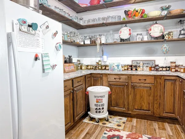 a kitchen with stainless steel appliances granite countertop a refrigerator and a sink