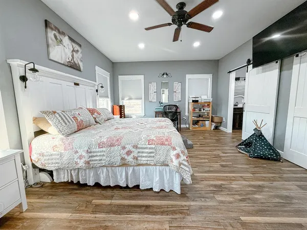 a bedroom with a bed and a mirror