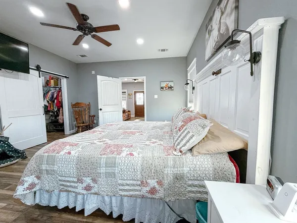 a bedroom with a bed and a flat screen tv