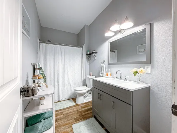 a spacious bathroom with a sink mirror and vanity