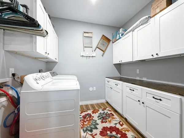 a kitchen with white cabinets and sink